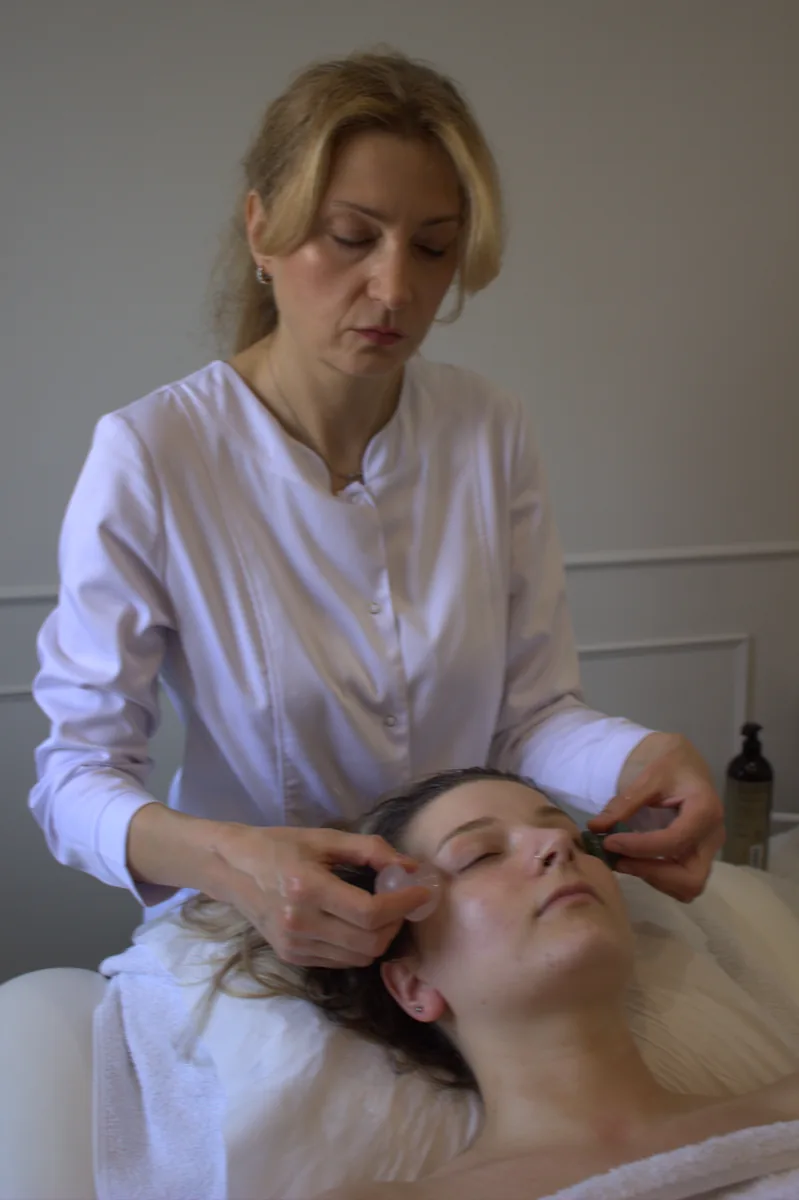 Seda performing a gua sha facial treatment